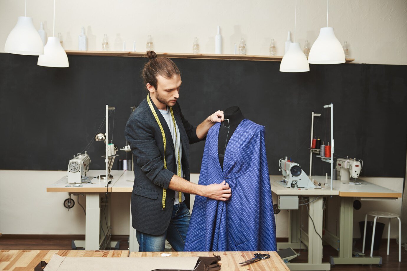 Navy custom suit on a wide-shouldered cedar hanger beside a horsehair clothes brush and breathable garment bag